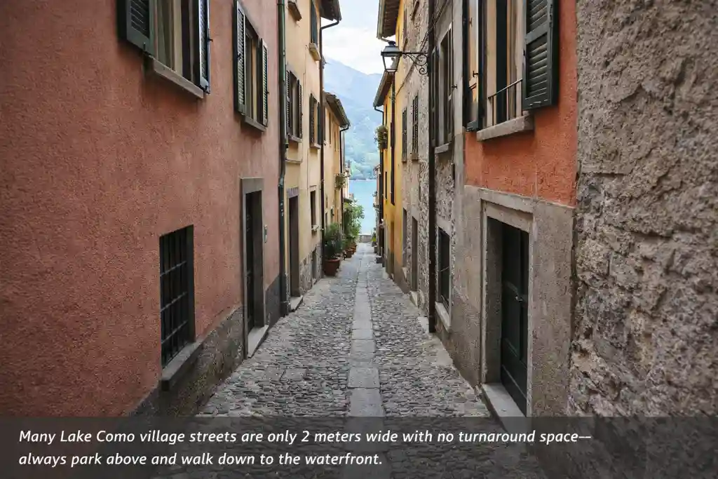 Narrow cobblestone street in a Lake Como village with tall houses and no space for vehicles to turn around