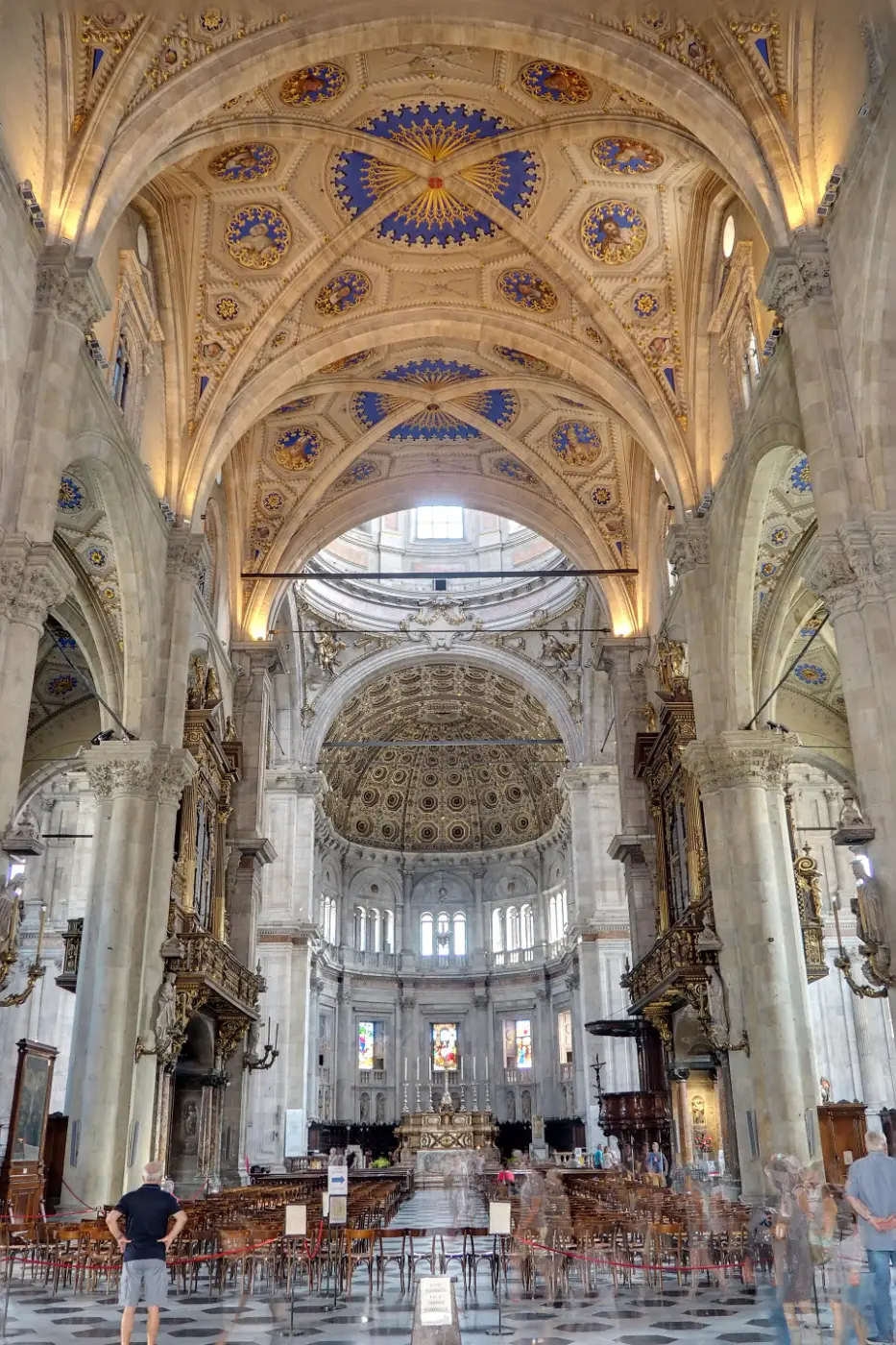 Gothic nave and painted vaults of Como Cathedral looking toward the domed apse