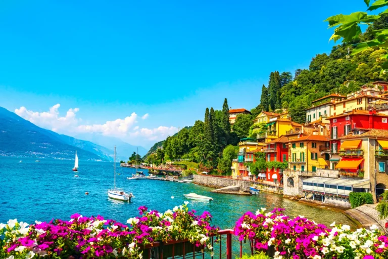 Home 2 Colourful houses along the Varenna waterfront on Lake Como with moored sailing boats